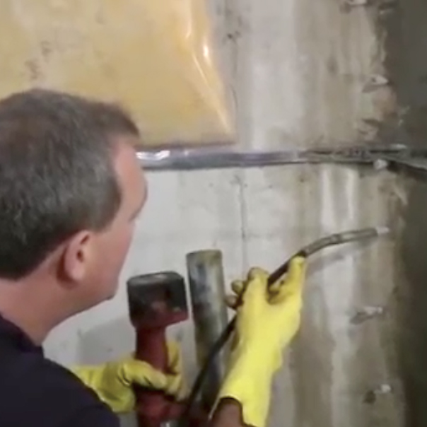 our concrete crack injection expert applying the solutions to fix a cracked concrete wall