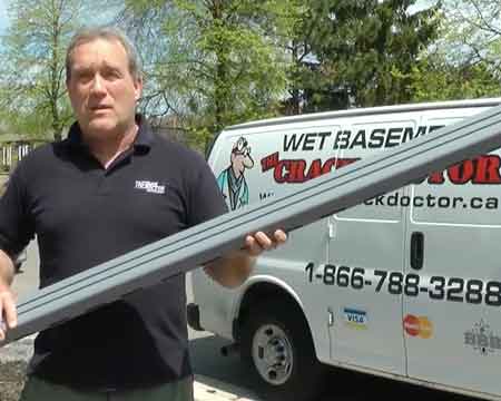 photo of waterproofing expert holding drainage pipe