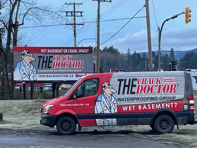 The Crack Doctor Waterproofing work van in front of new billboard in Duncan, BC